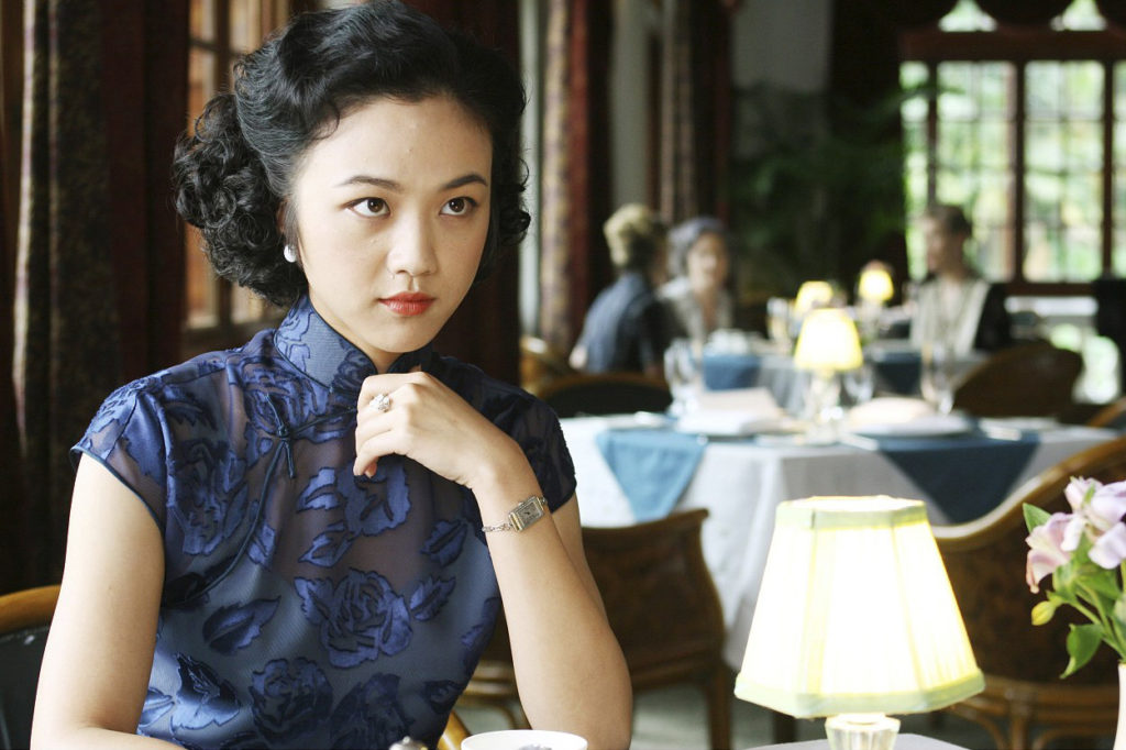 The central character of the film Lust, Caution, wearing a 1940s qipao, characterised by small sleeves, low collar, simple pankous and subdued colour; still from film