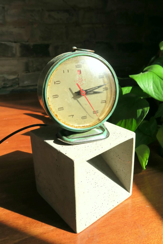 The front of the clock, grease from the kitchen has built up around the edge of the glass face over the years. 