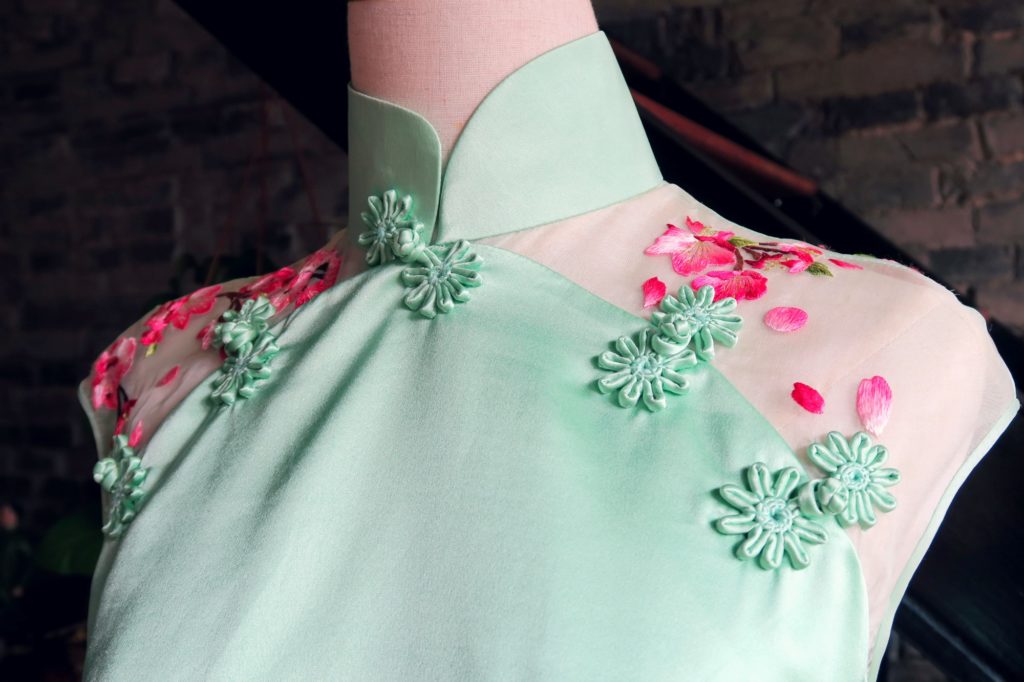 Close up shoulder detail ofmy mint and magenta modern wedding qipao