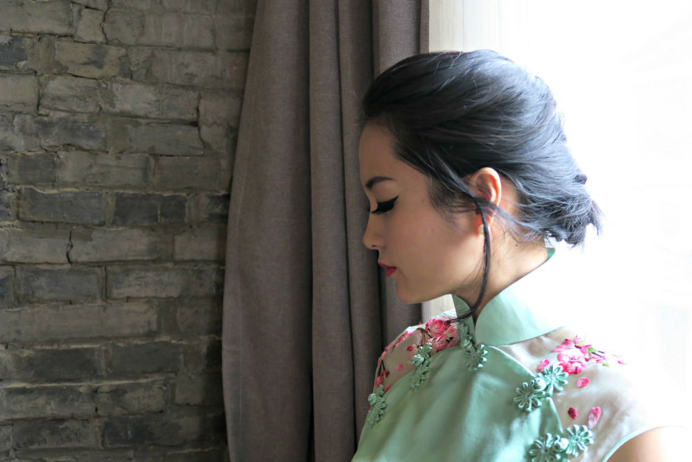 Miranda's headshot on thepankou.com wearing mint green wedding qipao