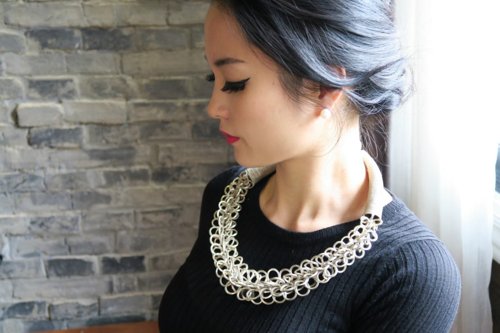 Side view of me wearing my silver Chinese Miao necklace