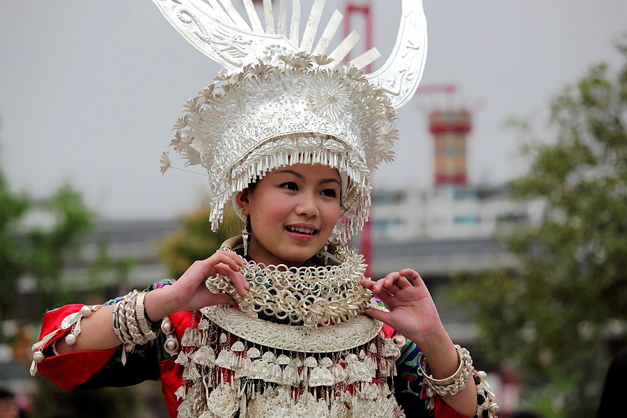 Image of a Miao tribe woman wearing her extensive silver jewellery collection