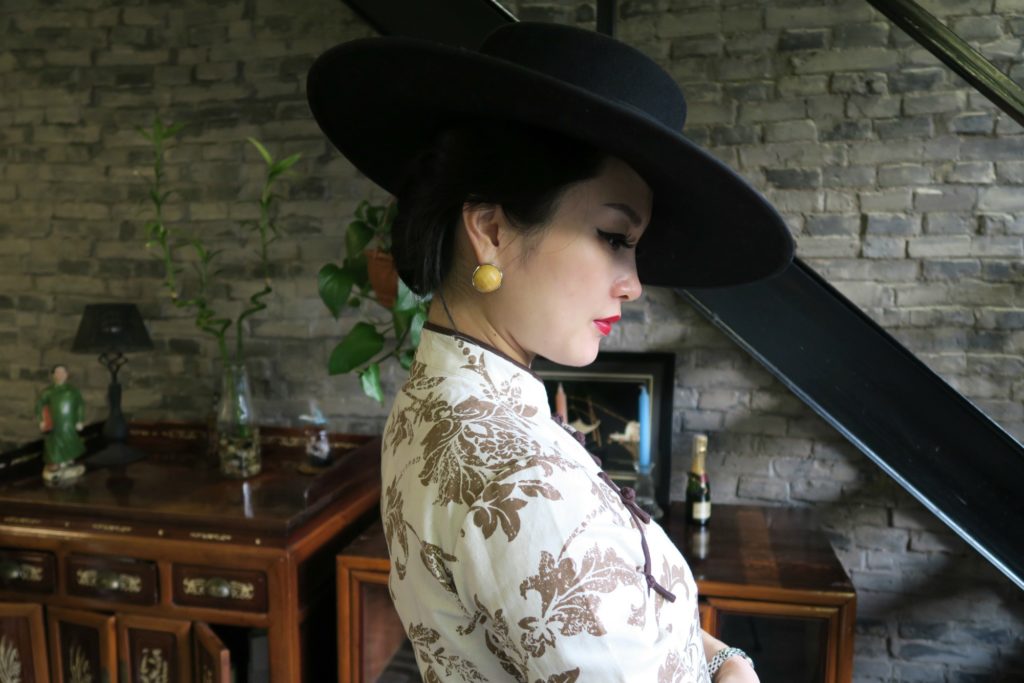 Accessorizing qipao cheongsam with large brimmed hat side view