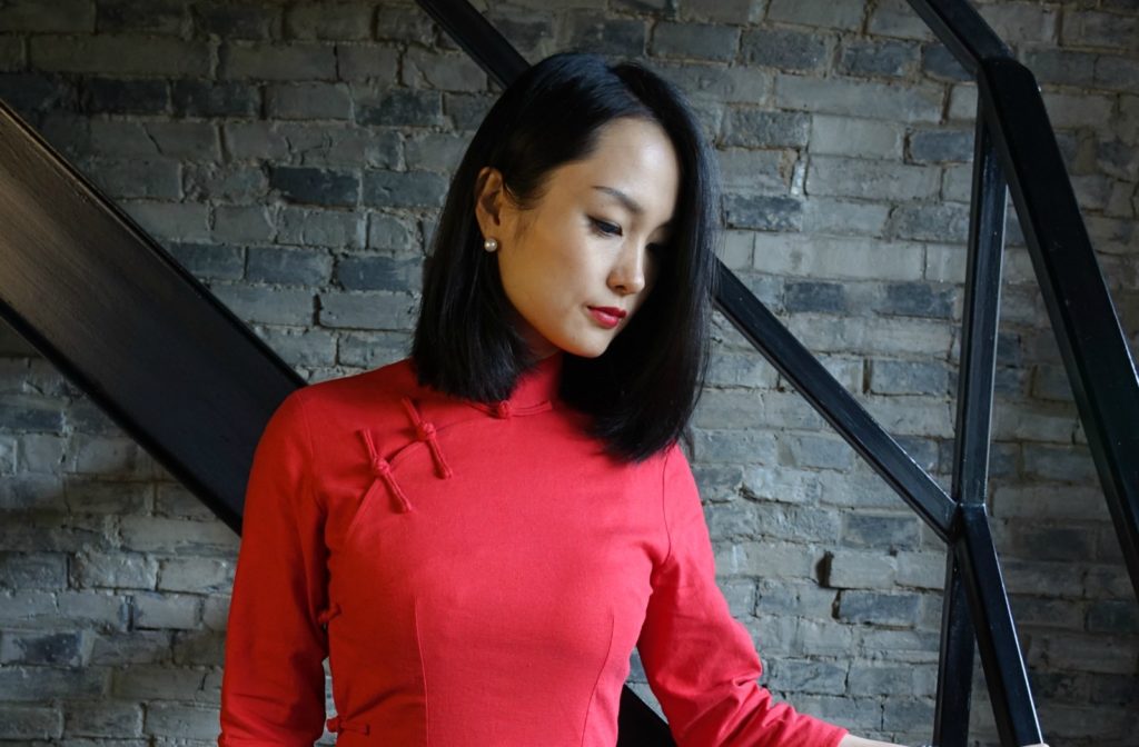 Traditional red qipao cheongsam top half view against staircase
