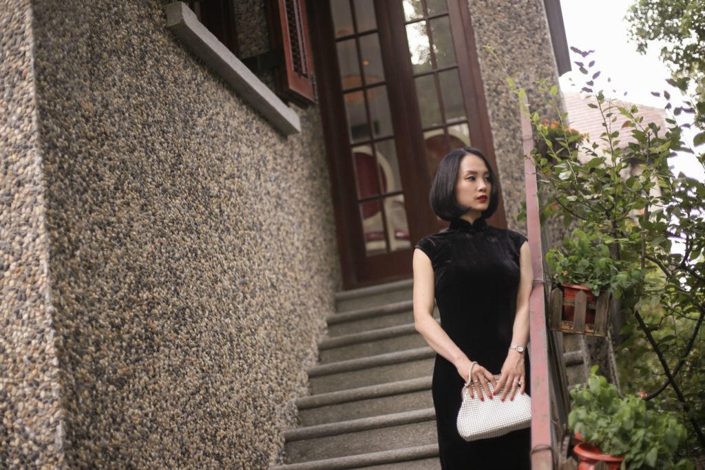 Miranda wearing black sleeveless velvet qipao Sinan Mansions steps