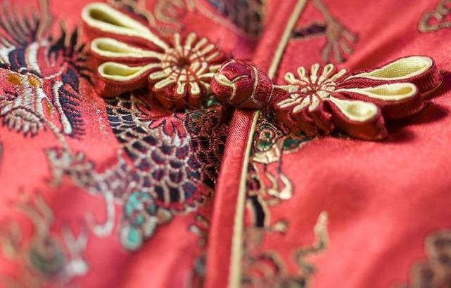 Red brocade qipao with edging and pankou details