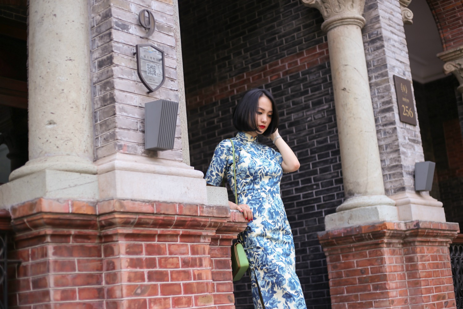 Wearing Blue and white qipao at Sinan Mansions Shanghai walking down stairs