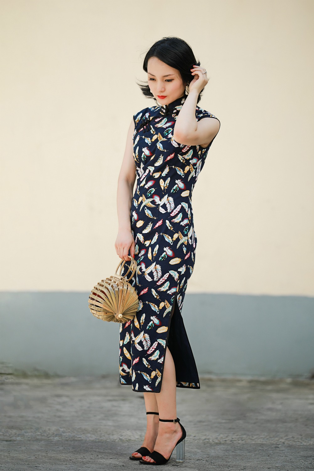 Cotton sleeveless navy feather print qipao full front view with bamboo bag