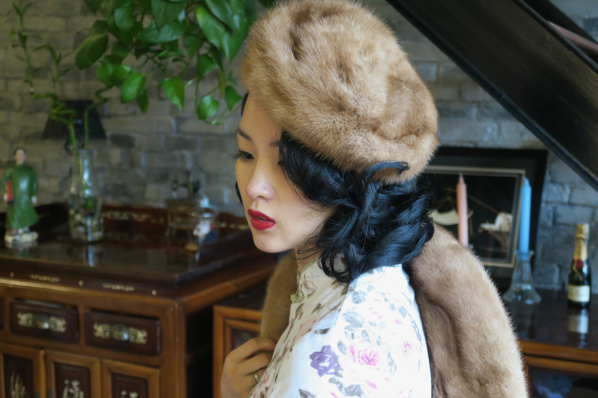 Wearing a qipao with vintage fur jacket and hat off shoulder view