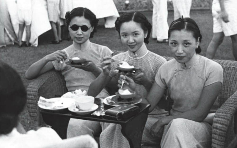 Three women wearing Shanghai-style qipao