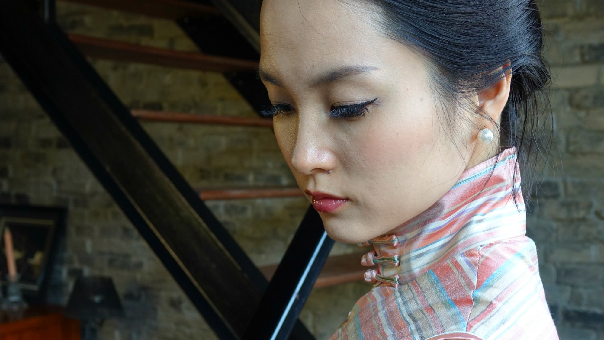 Wearing pink striped sleeveless qipao headshot